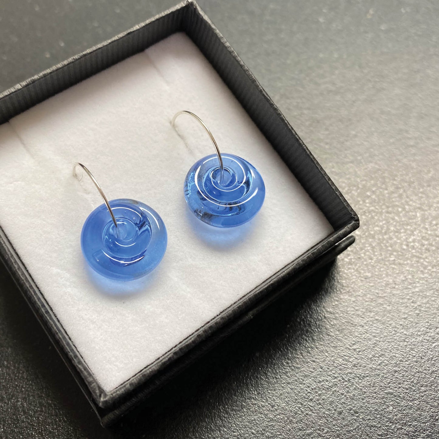 Lampwork glass spiral earrings in blue glass.